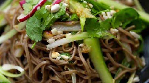 Healthy salad noodle salad bowl spinning in close up. Wholefoods and vegetarian dishes. Healthy plan