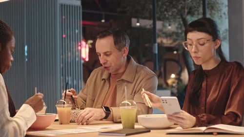 Multiethnic Colleagues Having Lunch Together in Restaurant
