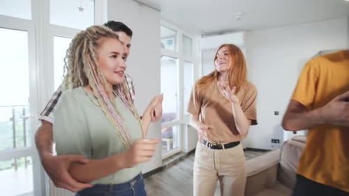 Joyful Friends and Family Dancing Together at Home
