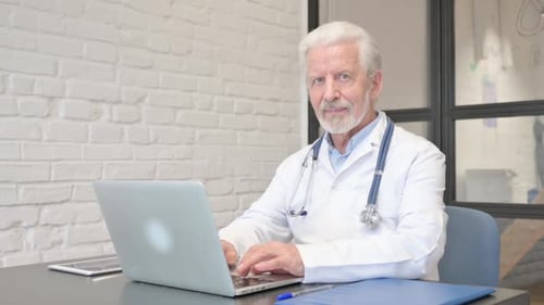 Young Mixed Race People Doing Paperwork in Office