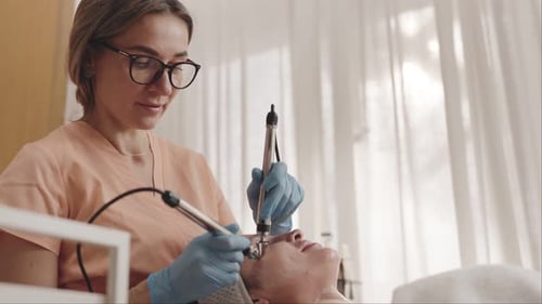 Woman Receiving a Facial Treatment in Medical Office