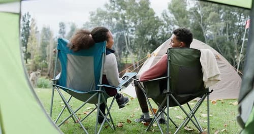 Child and Young Adult Relaxing in Camping Chairs