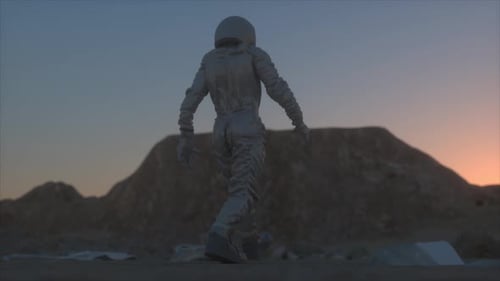Lone Astronaut Walking on Alien Planet at Twilight With Mountain Silhouette