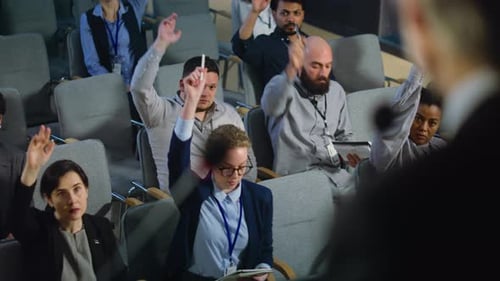 Audience Raises Hands at Corporate Conference