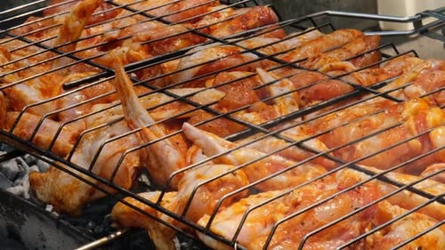 Delicious Chicken Frying on Barbecue Grill Grate Outdoor Seasoning Falling on Fresh Grilled Chicken