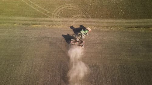 Tractor on the field seeding wheat
