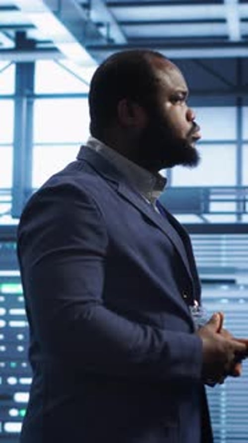Vertical Video IT Specialist Doing Evaluation of Data Center Workspace