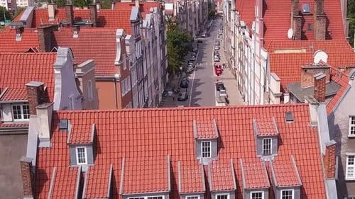 Gdansk Old Town Drone Footage. Rise shot over a narrow street between old historical buildings. Gdan