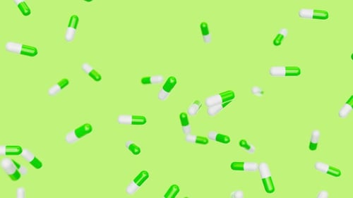 Green Capsules Slowly Fall Against Green Backdrop Drugs Pills Tablets Medicine Concept 3d Render