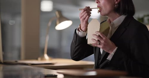 Woman, night and hands eating Chinese food on break, rest or supper on computer at office