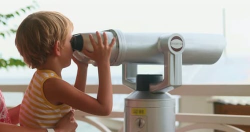 Child Looks Through Viewfinder in Bright Light