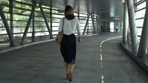 Businesswoman Walking Through Tunnel in City, Super 240