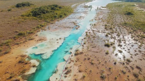 Vue aérienne de l'étroit canal turquoise Canal de los Piratas de Bacalar avec des gens marchant le long de deux