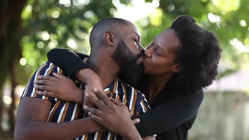 Beautiful black African couple kissing at park and posing. loving relationship