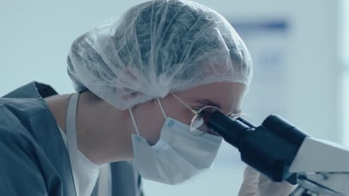 Close Up of Scientist Using Microscope in Lab