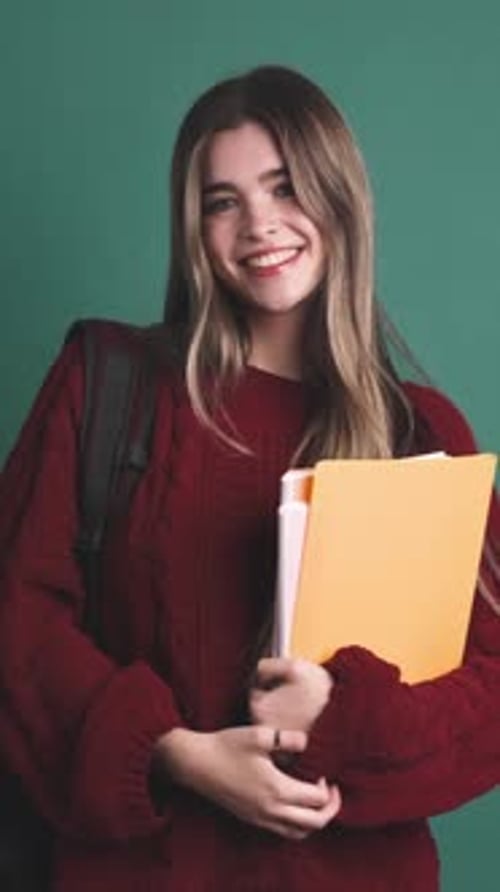 Smiling Woman Holding Books in Portrait Close Up