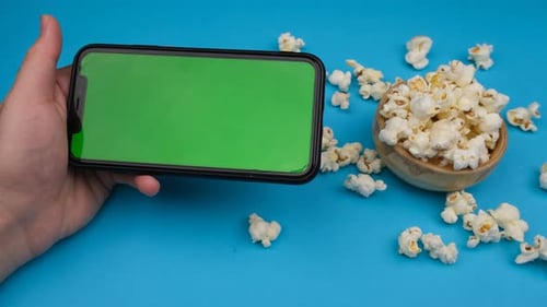 Smartphone with Green Screen and Popcorn