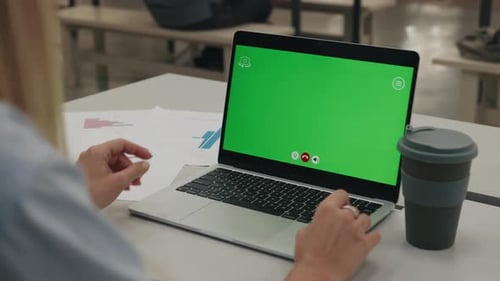 Businesswoman Interacts with Laptop Featuring Green Screen
