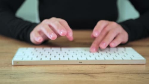 Close up female hands typing on PC keyboard.