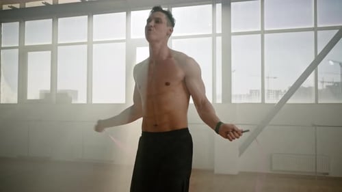 Young Athlete Doing Cardiovascular Exercise Indoors Exercising with a Jumping Rope