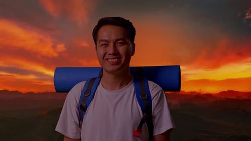 Close Up Of Asian Male Smiling To Camera On Top Mountain