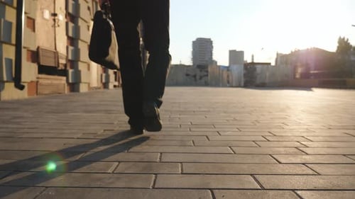 Man Walking with Bag in Urban Setting