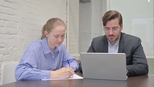 Smiling Business People Looking at Camera while Working in Office
