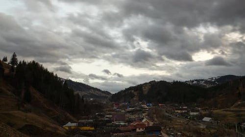 Dramatic Clouds moving over mountain village set in a picturesque location