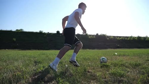 Professional Footballer in Uniform Shows Tricks with Ball While Running at Green Field Sportsman