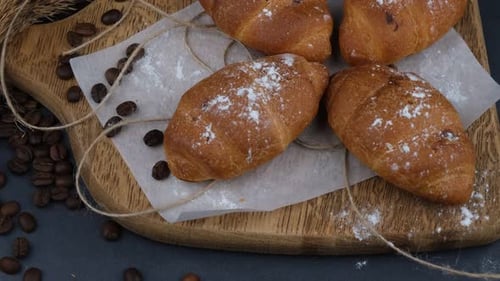 Delicious Croissants with Powdered Sugar and Coffee