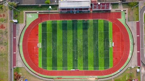 Drone view from top of soccer field with football player. Football stadium. Outdoor sports