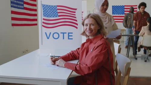 Portrait of Smiling Mature Woman with Ballot at Voting Booth