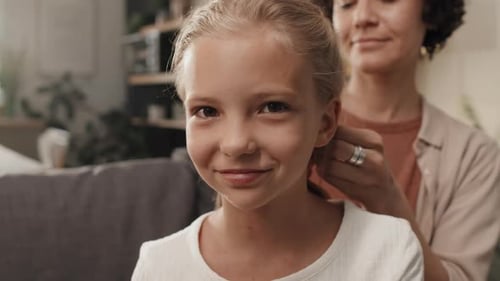 Happy Girl With Mom Doing Her Hair