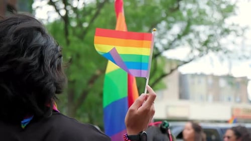 Pride Celebration with Rainbow Flags in Urban Setting