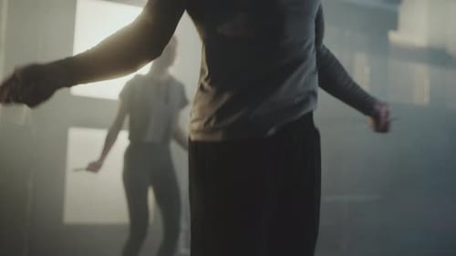 Adults Exercising With Jump Ropes in Industrial Gym