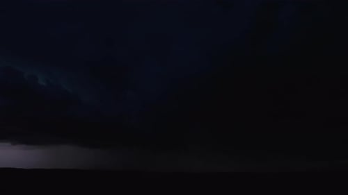 Dramatic Lightning Storm at Night over Dark Landscape