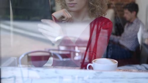 CU TD TU Woman drinking coffee and using digital tablet in cafe