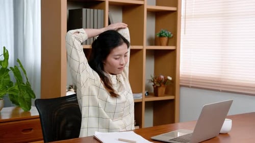 Woman Stretching at Desk During Workday