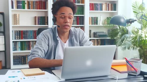 Young Charismatic African American Man Making Video Call in Laptop in Office