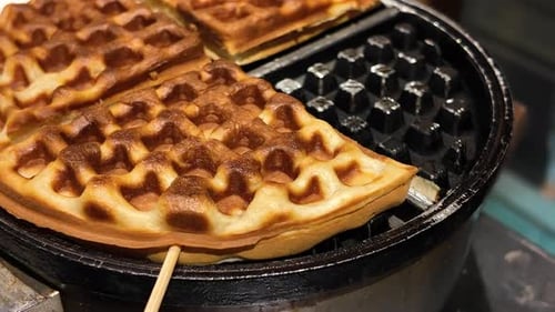 Golden Brown Waffles Cooking in a Waffle Iron