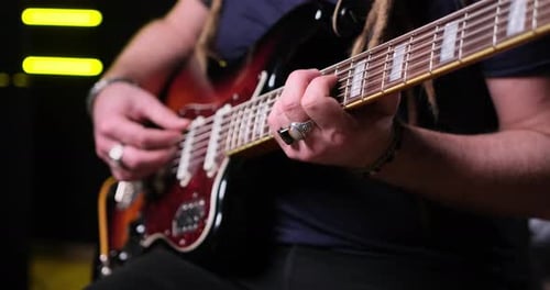 Guitarist Man Plays an Electric Guitar Closeup at Studio
