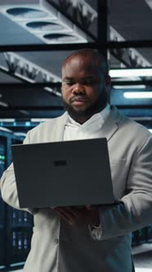 Vertical Video Data Center Engineer Analyzing Equipment Performance Resolving Technical Issues