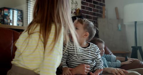 Family Relaxing Together at Home on Couch