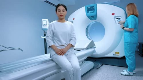 Technical Assistant Preparing Scan with Magnetic Resonance Tomography MRI in Radiology Patient