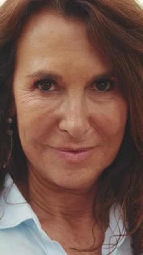 Close-up of beautiful elderly woman smiling while looking at the camera