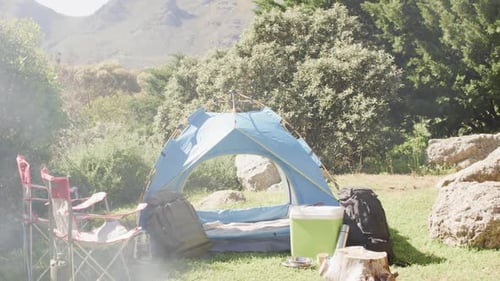 Camping Tent Setup with Fire Pit in Nature