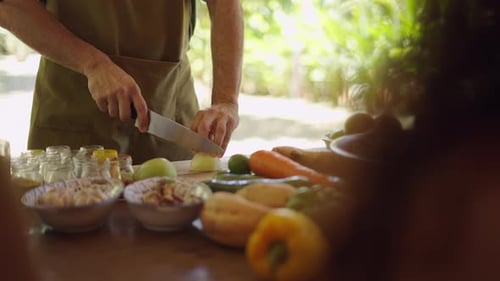 Chef Cuts Fresh Produce in Tropical Garden