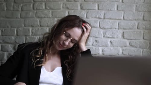 Young Woman Working on Her Laptop Computer in Coffee Shop