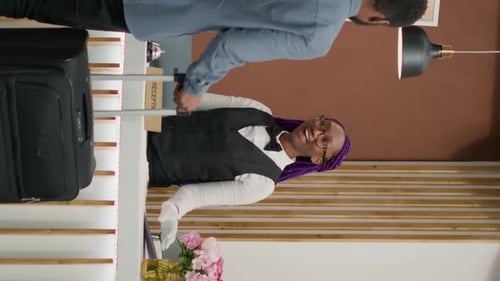 Hotel Receptionist Helping Guest Check In