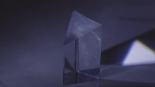 Light Passing Through Triangular Glass Prism. closeup
